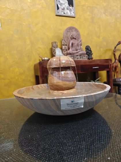 The light catches the beautiful patterns of the Rainbow Sandstone in this tabletop fountain.