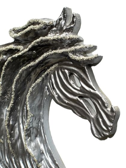 The powerful and graceful lines of the horse's head, sculpted from upcycled paper and textured to create a sense of movement.