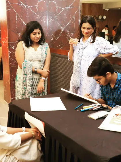 Beyond large concerts, we provide engaging artists for corporate and private gatherings. Here, a guest enjoys a live caricature session during a get-together for Fern Hotels & Resorts, showcasing our ability to provide interactive entertainment for any occasion.