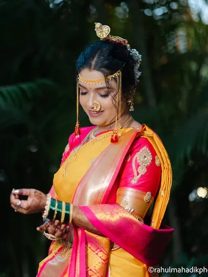 A candid shot of the bride adjusting her bangles, looking elegant and poised.