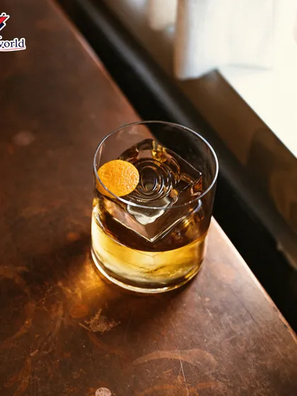 A classic whiskey on the rocks, elevated with a perfectly clear ice cube and an orange peel garnish. We believe even the simplest drinks deserve to be served with style.