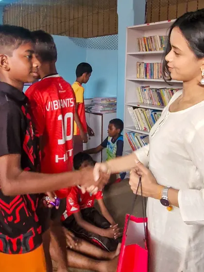 A young boy shakes hands with Megha Ray, a moment of mutual respect and connection. We are so grateful for friends who use their platform to support our cause.