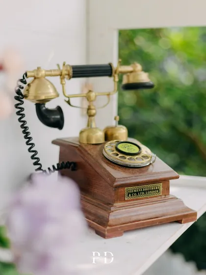 A vintage telephone prop used as a decor detail for a retro-themed Mehendi. It's these quirky, unexpected touches that make an event memorable.