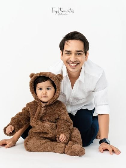 A proud father with his adorable little bear. Including parents in the shoot adds a layer of warmth and love to the photos.