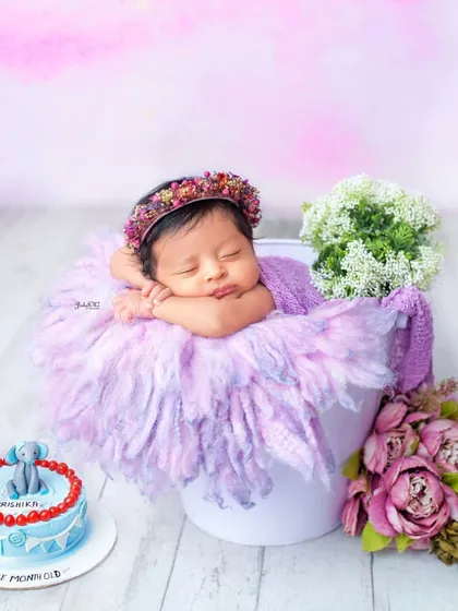 Celebrating one month with a special cake. This photo combines a classic newborn pose with a milestone celebration, making it an extra special memory.