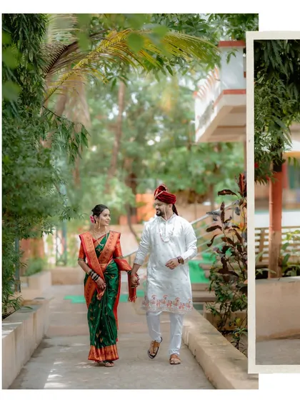 A candid shot of the couple walking together, showcasing their beautiful wedding outfits and the natural, relaxed environment of their celebration.