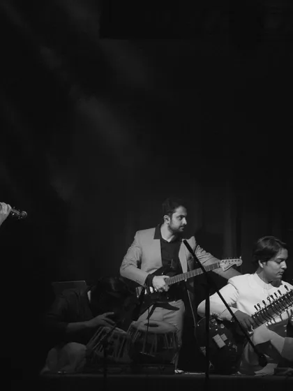 The violin, guitar, and sitar in perfect harmony. This shot captures the fusion element of my band, where different musical traditions come together to create something new and exciting.
