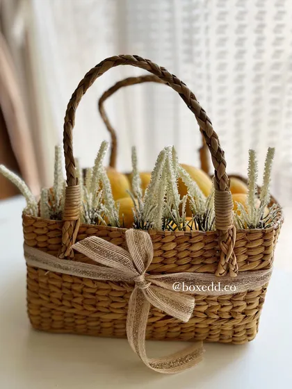 This mango hamper, featuring fresh mangoes in a rustic wicker basket, is a unique and seasonal gift perfect for summer occasions.