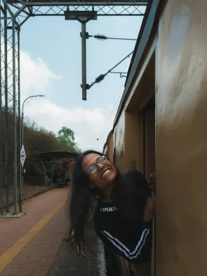 The journey is just as important as the destination. This shot of pure happiness while leaning out of a train captures the spirit of travel itself. I look for these small, authentic moments that define an entire trip.