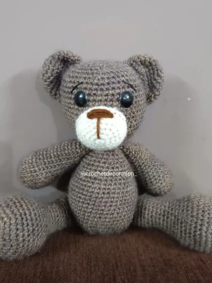 You can never go wrong with a classic, and our custom crochet teddy bear is a perfect example. This one was made with a lovely brown-flecked yarn, featuring safety eyes and a hand-stitched nose, ensuring it's a safe and timeless toy for children.