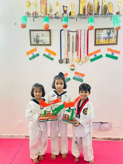 Celebrating our nation with our youngest champions. They are holding models of the Indian flag, learning about patriotism alongside their Taekwondo training.
