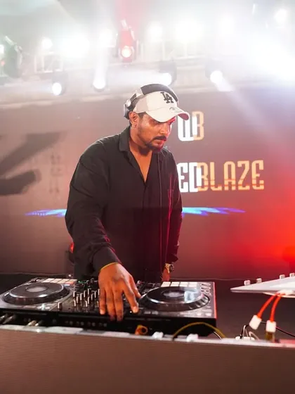 Here I am in my element, locked in on the mix. A professional setup with my "Wicked Blaze" branding means you get a premium audio and visual experience for your event.
