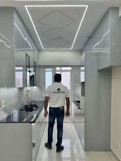 Another perspective of the sleek grey kitchen, highlighting the high-gloss finish and the clean, minimalist design.