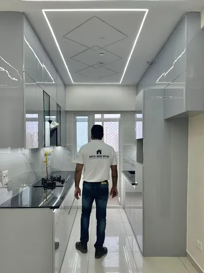 Another perspective of the sleek grey kitchen, highlighting the high-gloss finish and the clean, minimalist design.