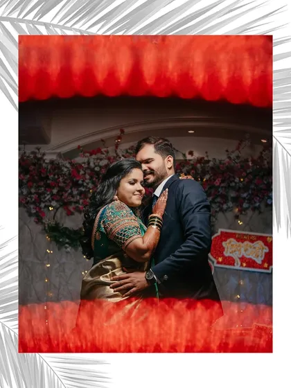 An artistic reception portrait of the couple. We used a creative framing technique to capture their embrace against the backdrop of their beautiful floral decor.