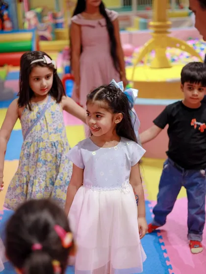 Holding hands and making friends during a magical Frozen-themed party.