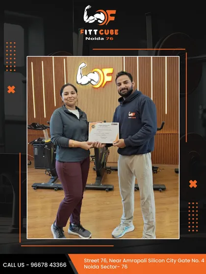Another success story at Fittcube. A member is awarded a certificate of achievement by her personal trainer for reaching her fitness goals.