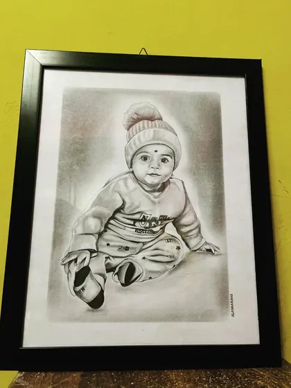 A framed A3 size pencil sketch of an adorable baby in a beanie. This was a commission work, and the black frame gives it a classic, finished look, ready to be gifted.