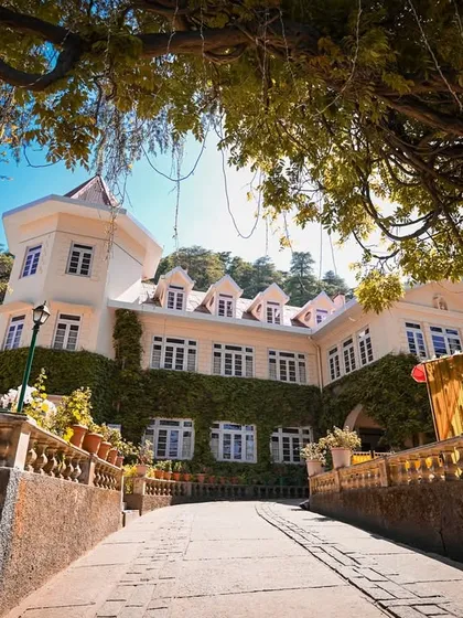 An architectural shot of the venue, the historic Woodville Palace in Shimla, setting the scene for a grand Mehandi celebration.