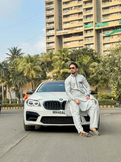 Style that moves with you. A client looking sharp in a custom light grey Pathani suit, showcasing how traditional wear can be both comfortable and effortlessly cool in an urban setting.