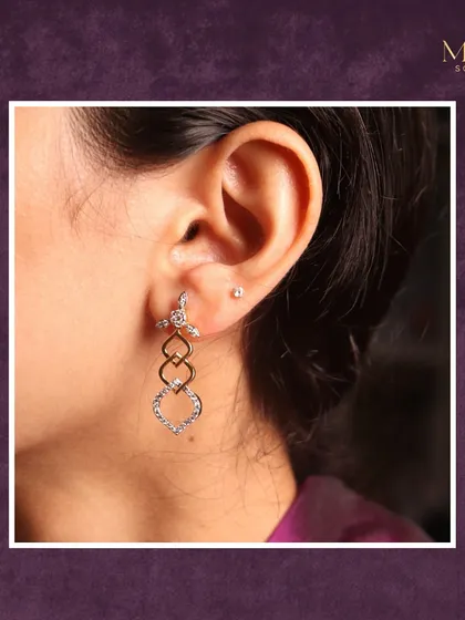 A closer look at these uniquely crafted diamond drop earrings. The interlocking shapes create a modern design that is perfect for elevating your everyday style.