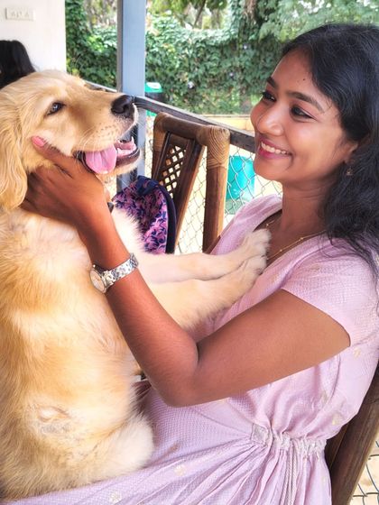 A guest enjoys a lap-full of Golden Retriever, a perfect example of the affection our dogs offer.