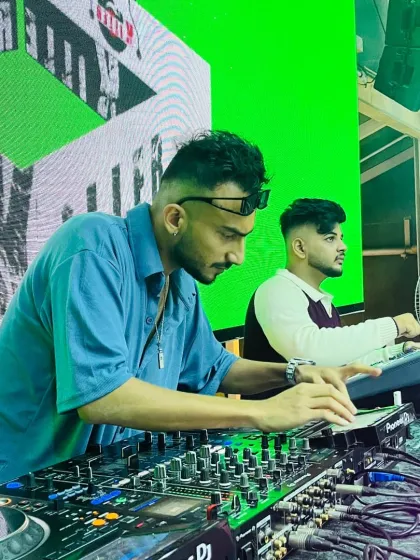Focused in the zone, crafting the perfect set. I use a Pioneer DJ setup to precisely mix and layer tracks, ensuring a seamless flow of energy all night long.