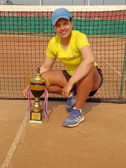 Samaira Malik with her finalist trophy on the clay court. Competing at the national level requires immense skill and mental fortitude, which we focus on in our training.