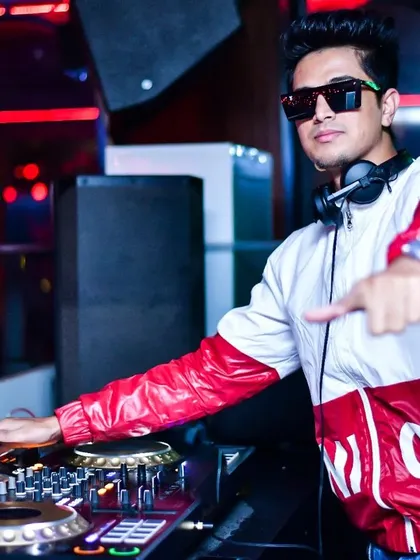 Behind the decks is where I belong. This is a shot of me in my element, focused on the music and the crowd's energy. I bring a professional setup and a stylish presence to every gig.