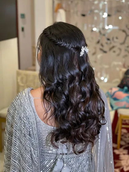 The back view of this half-up, half-down hairstyle. It's a versatile look that works beautifully with a saree or a lehenga.