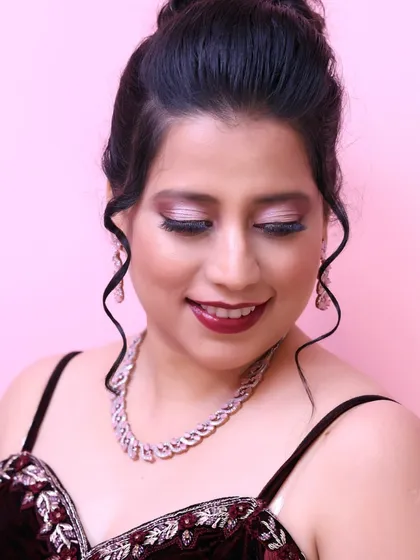 A close-up of the eye makeup. The blend of maroon and silver eyeshadow creates a sophisticated and glamorous effect.