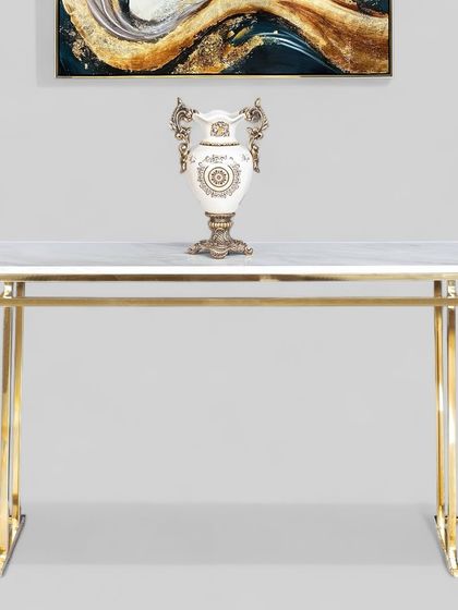 This chic console table brings function and style to any living room or entryway. Designed with a sturdy eight-leg stainless steel frame in a golden finish, it features a smooth artificial marble top perfect for displaying your favorite decor.