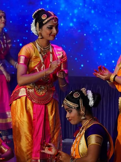 A candid moment of interaction between performers on stage during our senior group presentation. These small moments of storytelling are what make a performance special.