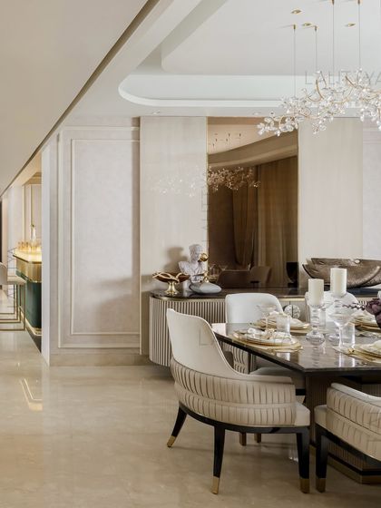 A view of one of our elegantly styled dining rooms. We focus on combining statement lighting, comfortable seating, and high-quality materials like marble and brass to create spaces that are perfect for both everyday meals and special occasions.