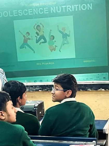 Collaboration is key. Here I am alongside a teacher during a nutrition session, working together to answer student questions and reinforce the importance of a healthy school environment.