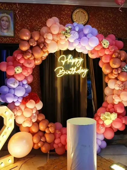 A full view of the second birthday setup, including a large light-up number '2' and a cake plinth.