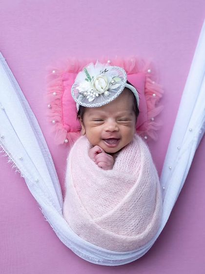 Capturing a sleepy smile from this little one in the pink hammock setup. These moments are pure gold.
