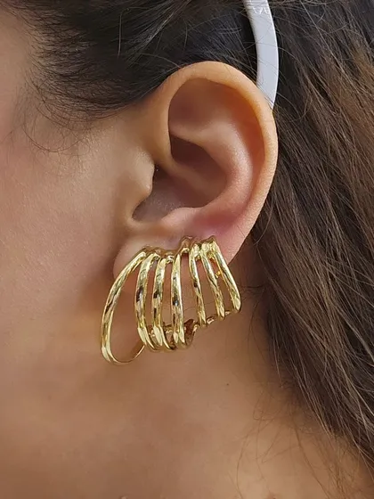 A close-up of our unique multi-hoop ear cuff earrings. This single piece gives the illusion of a full stack of hoops, offering a bold and modern look with minimal effort.