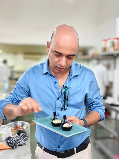 Art on a plate, crafted with passion. Here I am in the kitchen, putting the finishing touches on an appetizer, ensuring it's perfect before it goes out.