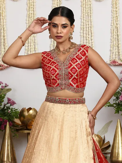 A close-up of the sleeveless red blouse, highlighting the detailed embroidery and the flattering V-neckline.