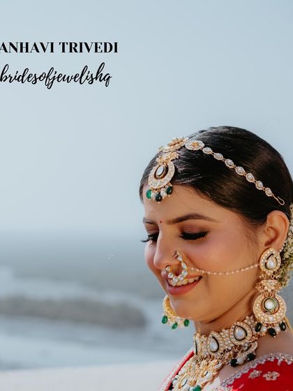 A serene bridal portrait showcasing a complete Jadau Polki set. The look includes an elaborate choker, matching oversized earrings, a nath, and a sheeshphool, creating a look of pure royalty.