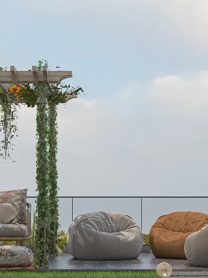This image highlights the casual lounging area of the terrace, featuring large, comfortable bean bags. The glass railing ensures an unobstructed view, making the space feel open and connected to the sky.