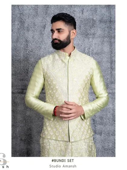 A closer view of the mint green bundi jacket. The detailed Resham embroidery creates a subtle, luxurious texture that elevates the entire ensemble.
