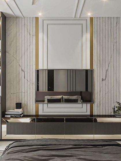 A master bedroom concept designed for rest and luxury. The TV unit wall features vertical fluting and marble accents, complemented by a built-in study desk and shelving.