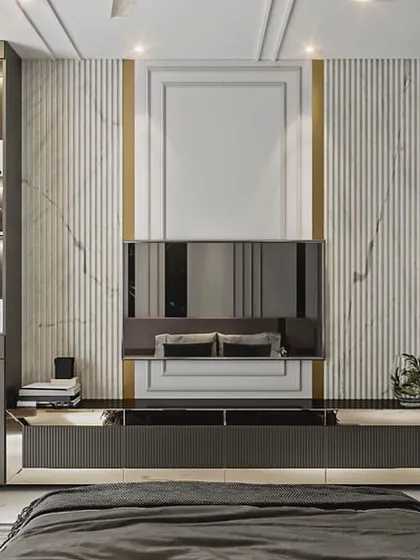 A master bedroom concept designed for rest and luxury. The TV unit wall features vertical fluting and marble accents, complemented by a built-in study desk and shelving.