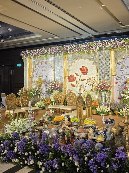 A side view of the painted rose backdrop stage, showing the layers of purple and white flowers in the foreground.