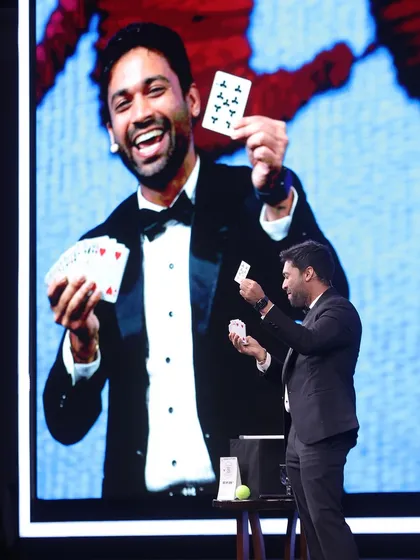 A classic card trick, but amplified for a huge stage. The energy you get from performing for over 500 people is insane. This shot captures that moment of pure joy and astonishment, both on my face and on the big screen for everyone to see.