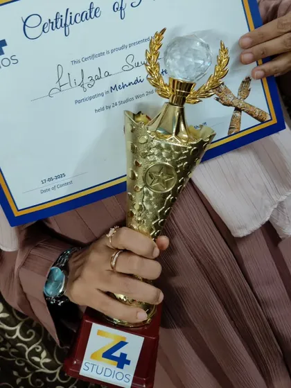 Another shot of my certificate and trophy. This motivates me to keep growing as an artist.