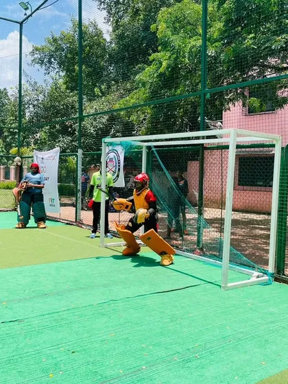 The goalkeeper is set and ready as a player approaches. Goalie training is about anticipation and positioning as much as it is about reflexes.