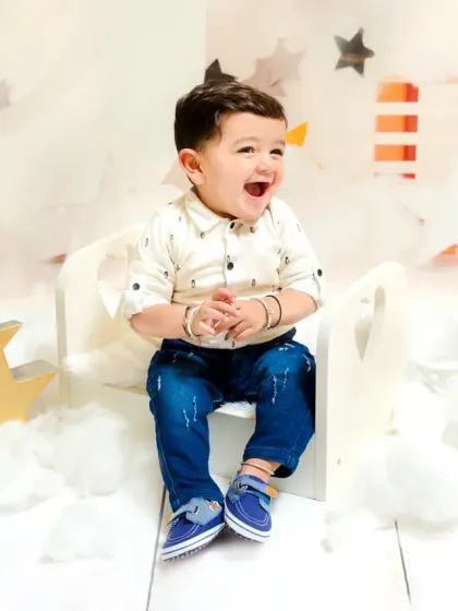 An ecstatic baby boy laughs with delight during his star-themed first birthday session. This is the kind of pure happiness I love to capture.